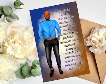May include: A greeting card with a cartoon illustration of a man in a blue shirt and black pants. The card has a message that reads "In a world where all of the odds are stacked against you. You still manage to be a protector, provider and a nurturer. Today we celebrate you. But know that you are loved each and every day King!"