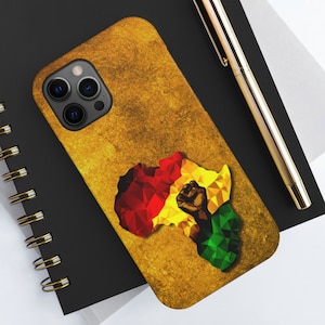 May include: A gold-colored phone case featuring a textured design and a geometric map of Africa in red, yellow, and green. The map includes a raised fist. The phone case is on a black notebook with a gold pen.