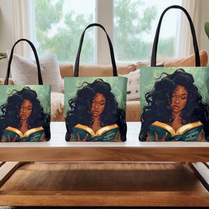 May include: Three tote bags of varying sizes, each featuring a woman with long, dark hair reading a book. The bags have black handles and a teal background. The woman is depicted with a serene expression.