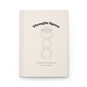 May include: A beige journal cover with the text "Thought Space" in black bold letters. A black and white illustration of a snake wrapped around an eye symbol is centered on the cover. The text "the journal that makes room for you to grow" is printed in brown below the illustration.