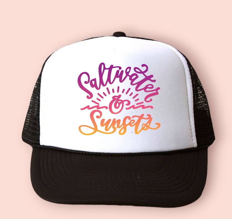 May include: A black and white trucker hat with a white front panel featuring the text "Saltwater & Sunsets" in a colorful gradient.