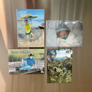 Puede incluir: Cuatro imanes rectangulares con fotograf&iacute;as. Uno muestra a una persona sosteniendo una tabla de surf en la playa. Otro muestra a un beb&eacute; envuelto en una manta. Un tercer im&aacute;n tiene el texto "Class of 2025". El &uacute;ltimo im&aacute;n muestra a personas haciendo tirolesa.