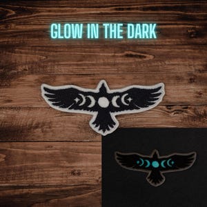 May include: A black and white embroidered patch in the shape of a bird with moon and star details. The patch has the words "GLOW IN THE DARK" in a neon blue font above it. A second image shows the patch glowing in the dark.