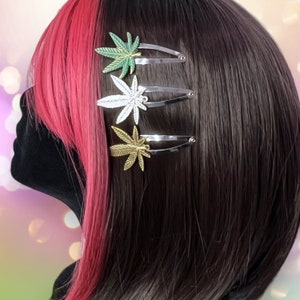 May include: A black and pink wig with four green and silver marijuana leaf hair clips.