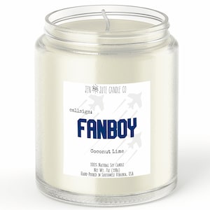 May include: A glass jar candle with a white label that reads "JEN JUTE CANDLE CO" and "callsign: FANBOY Coconut Lime". The label also includes the text "100% NATURAL SOY CANDLE NET WT. 7oz (198g) HAND-POURED IN SOUTHWEST VIRGINIA, USA".