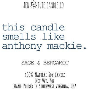 May include: A candle with the text "this candle smells like anthony mackie." The candle is labelled "SAGE & BERGAMOT" and is described as a "100% NATURAL SOY CANDLE" with a net weight of 7 oz. The candle is hand-poured in Southwest Virginia, USA.