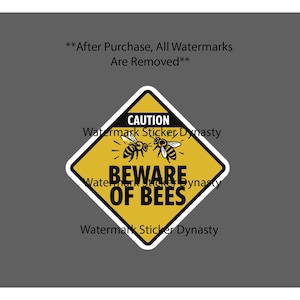 May include: A diamond-shaped yellow caution sign sticker featuring a black border and white outline. The graphic includes two black and white illustrations of bees and the bold black text CAUTION BEWARE OF BEES centered on the yellow background.
