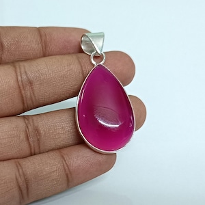 May include: A teardrop-shaped pendant with a pink agate gemstone set in sterling silver.
