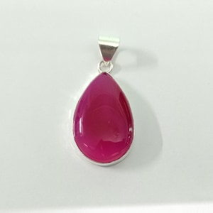 May include: A silver pendant featuring a teardrop-shaped pink agate gemstone.