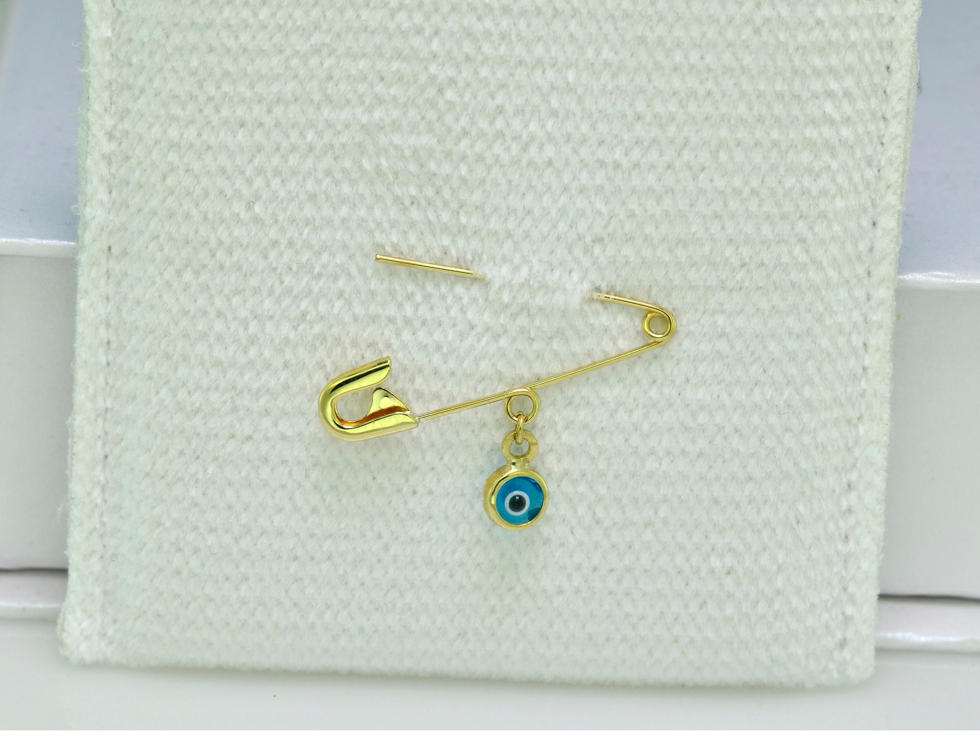 14 KT Diaper Pin with glass eye charm.