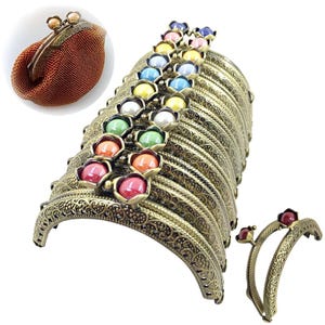May include: A collection of antique bronze-colored purse frames with decorative floral accents and colorful, round beads. One purse frame is shown with a small, brown, beaded purse. The frames have an ornate, vintage design.