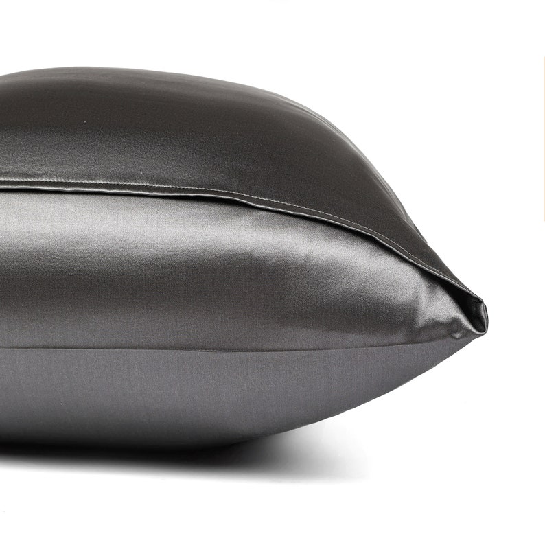 May include: A charcoal gray satin pillowcase with a smooth, silky texture.