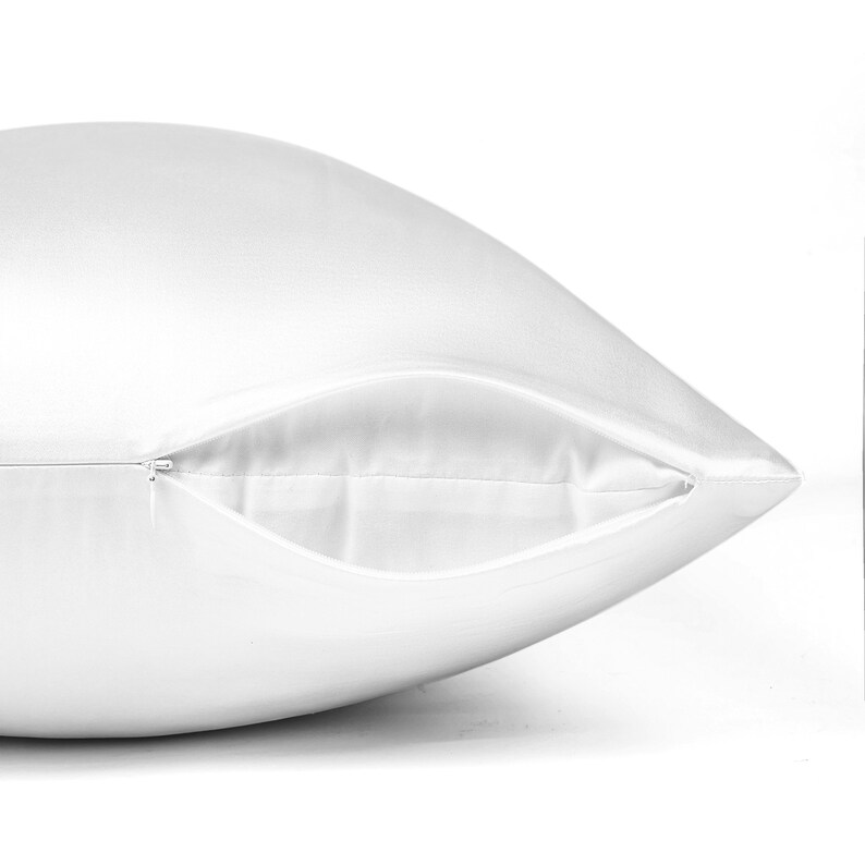May include: A white satin pillowcase with a zipper closure.
