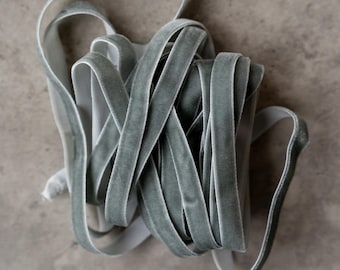 May include: A bundle of sage green velvet ribbon. The ribbon is soft and luxurious, perfect for adding a touch of elegance to any project.