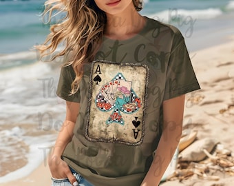 May include: A green t-shirt featuring a vintage-style illustration of the Ace of Spades playing card. The card depicts a woman wearing a hat against a chequered background.