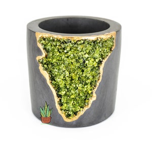 May include: A gray concrete planter with a gold rim and a green crystal geode design. The planter is perfect for small plants or succulents.