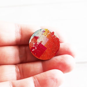 Modern orange round wooden pin badge