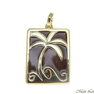 May include: Gold-tone pendant with a rectangular, dark brown center featuring a stylized palm tree design. The palm tree is outlined in gold, with a gold border around the pendant. The pendant has a loop for a chain.
