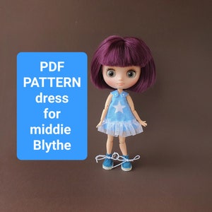 May include: PDF pattern for a dress for a middie Blythe doll. The doll is wearing a blue dress with a white star and a white lace trim. The doll has purple hair and blue shoes.