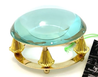 May include: A vintage magnifying glass with a round, light blue glass lens and a gold metal base with four decorative feet. The base is shaped like a ring. The magnifying glass is on a white surface. The image also includes a black and white tag with the text "Ministry of Antiques UK Seller Same Day Dispatch".
