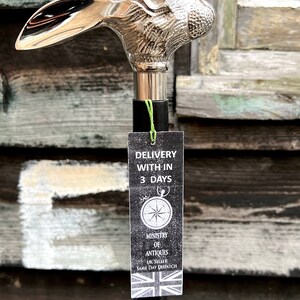 May include: A silver rabbit head walking stick with a black shaft. The stick has a tag attached that says "Delivery within 3 days" and "Ministry of Antiques UK Seller Same Day Dispatch".