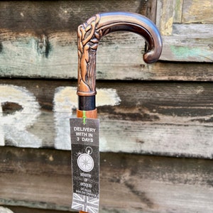 May include: A copper-colored walking stick with a detailed, ornate handle. The stick has a wooden shaft and a tag that reads "Delivery with in 3 days" and "Ministry of Antiques UK Seller Same Day Dispatch".