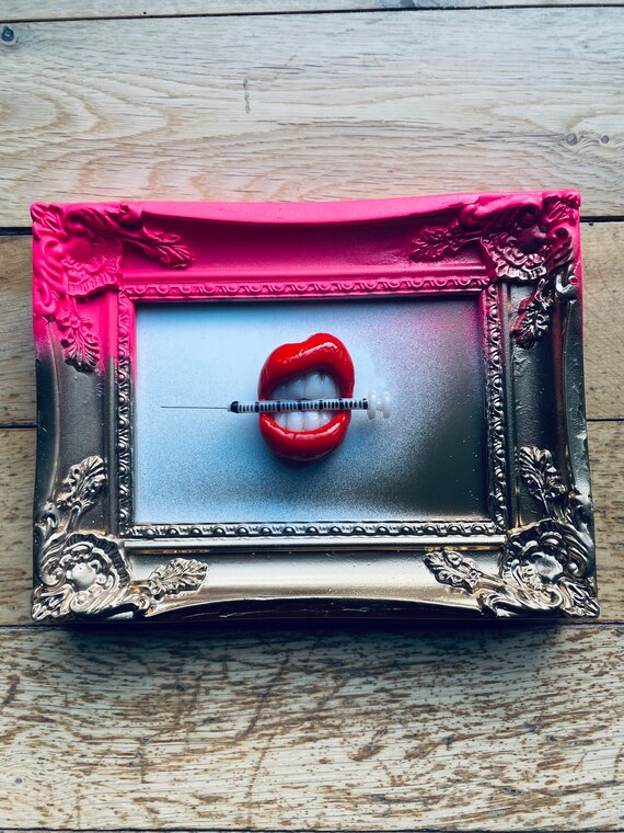 Neon Pink & Gold frame - with red lips holding an aesthetic syringe