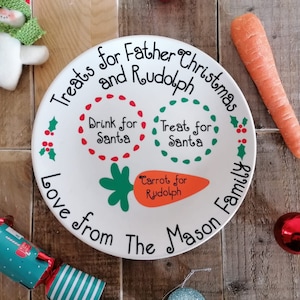 May include: White ceramic plate with a Christmas-themed design. It says "Treats for Father and Rudolph Christmas Love from The Mason Family". There are three circles with the text "Drink for Santa", "Treat for Santa", and "Carrot for Rudolph".