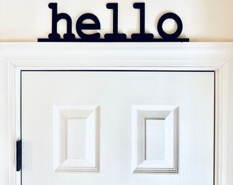 Letrero de madera negro para puerta con la palabra HELLO, Trim Sitter