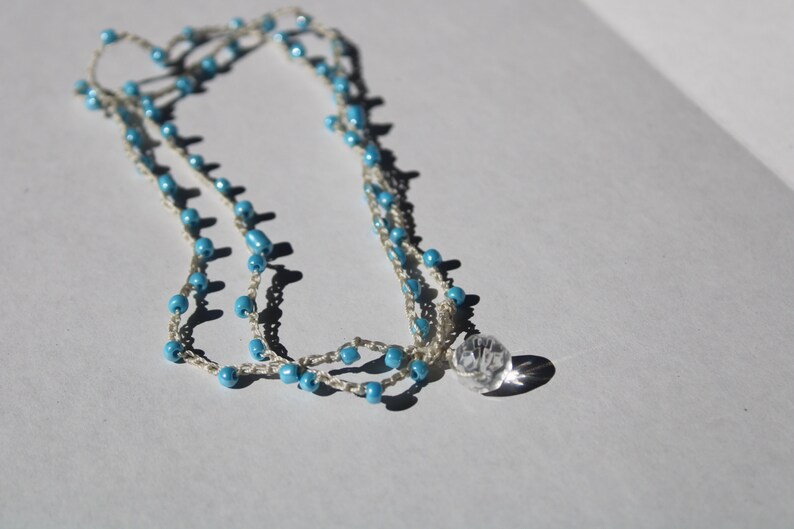 layered beaded crochet necklace with light blue beads