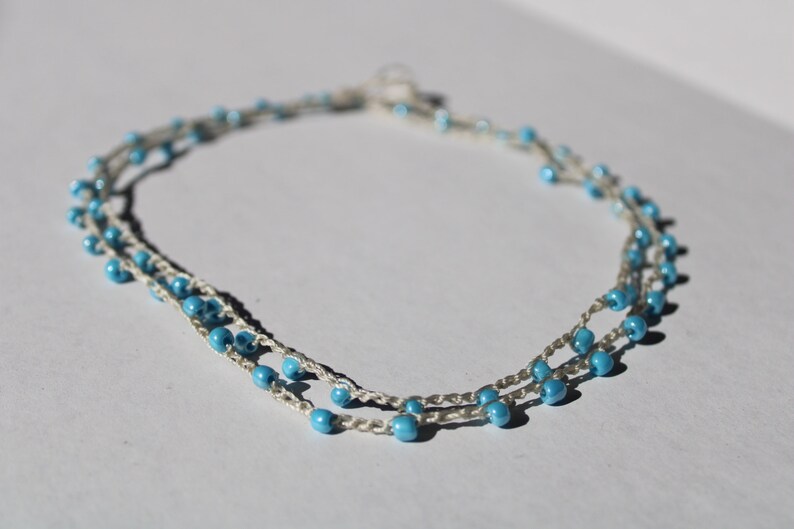 layered beaded crochet necklace with light blue beads