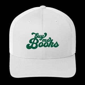May include: White mesh trucker hat with a green embroidered design that says "buy me books" in a retro font.