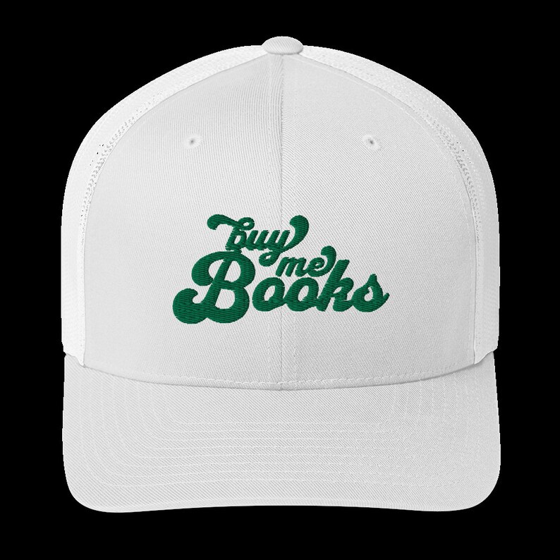 May include: White mesh trucker hat with a green embroidered design that says "buy me books" in a retro font.