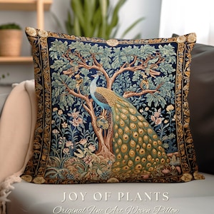May include: Square woven pillow with a peacock design. The pillow features a detailed illustration of a peacock perched on a tree, with a dark blue background and gold trim. The text "JOY OF PLANTS" is at the bottom.