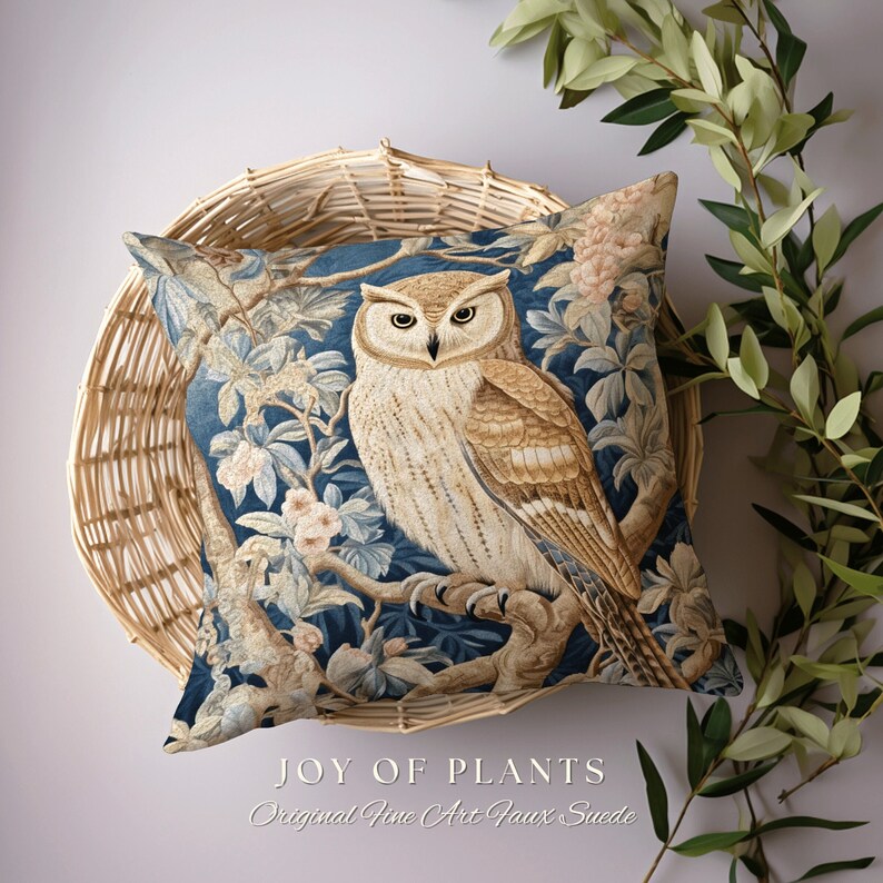 May include: A blue and brown throw pillow with an owl perched on a branch surrounded by flowers. The pillow features the text "JOY OF PLANTS Original Fine Art Faux Suede".