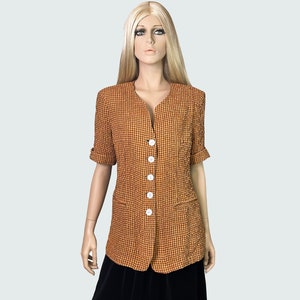 May include: A short-sleeved orange and red checkered blazer with white buttons. The blazer has a v-neck and two pockets.