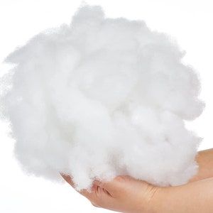 May include: A large amount of white polyester fiberfill, commonly used for stuffing pillows, cushions, and toys.