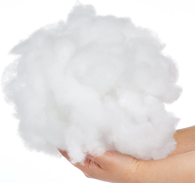 May include: A large amount of white polyester fiberfill, commonly used for stuffing pillows, cushions, and toys.