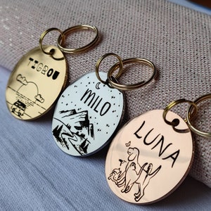 Personalized dog/cat medal with telephone number, address, drawing. Round identification label.