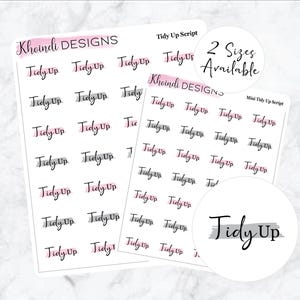 May include: A sheet of stickers with the text "Tidy Up" in a handwritten script font. The stickers are in two sizes and have a pink and grey watercolour design. The text "Khoindi Designs" appears at the top of the sheet.