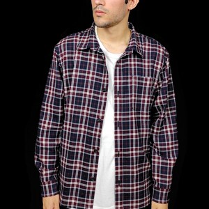 May include: A long-sleeved plaid shirt in shades of red, white, and blue. The shirt has a button-down collar and a relaxed fit.