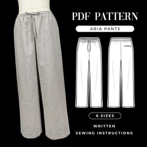 May include: A PDF pattern for Aria pants featuring a pair of light gray wide-leg trousers with an elastic waistband and drawstring. The image includes a technical line drawing showing front and back views, the text PDF PATTERN, and 6 SIZES.