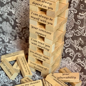 May include: A stack of wooden blocks with positive affirmations written on them. The blocks are arranged in a tower, with the top block reading "I can always depend on you". The blocks are made of light wood and have a natural finish.