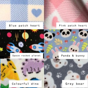 May include: A collage of six fleece fabric patterns: blue and white checkered hearts, pink checkered hearts, a black space print with rockets and planets, a blue background with pandas and bunnies, a white print with colorful dinosaurs, and a grey bear print.