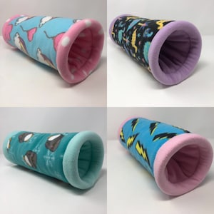 May include: Four different patterned fleece pet tunnels. The tunnels are all blue with pink lining and feature different patterns: unicorns, lightning bolts, penguins, and dinosaurs.