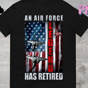 May include: Black t-shirt featuring an American flag design with the text "An Air Force Legend Has Retired". Two fighter jets are flying in front of the flag.