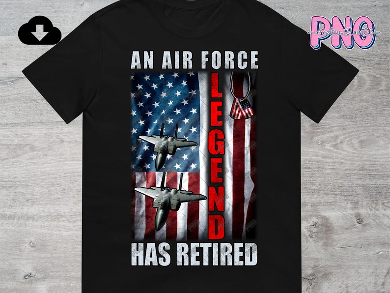 May include: Black t-shirt featuring an American flag design with the text "An Air Force Legend Has Retired". Two fighter jets are flying in front of the flag.