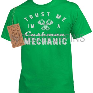 May include: Green t-shirt with white text that reads "Trust me I'm a Cushman Mechanic" with a graphic of two crossed wrenches.