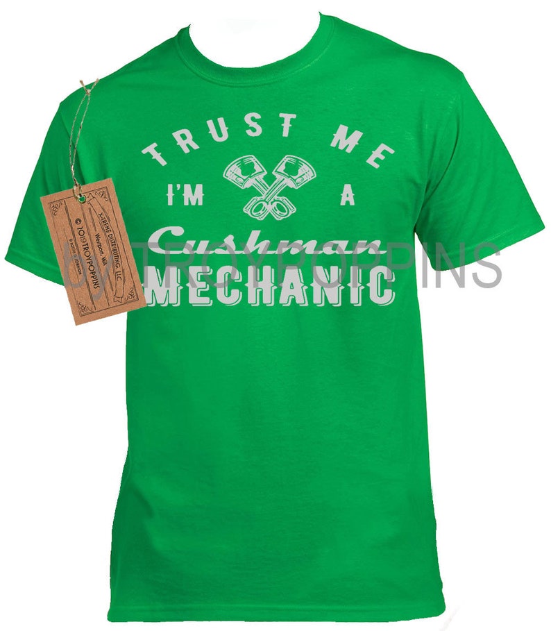 May include: Green t-shirt with white text that reads "Trust me I'm a Cushman Mechanic" with a graphic of two crossed wrenches.