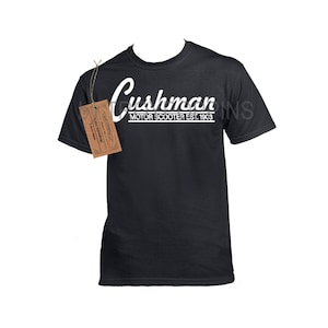 May include: A black t-shirt with white text that reads "Cushman Motor Scooter Est. 1903".